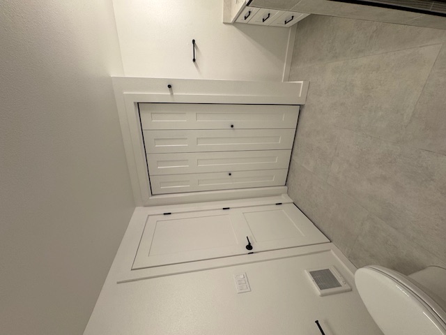 Bathroom remodel — wide view with closet, vanity, and tile floor