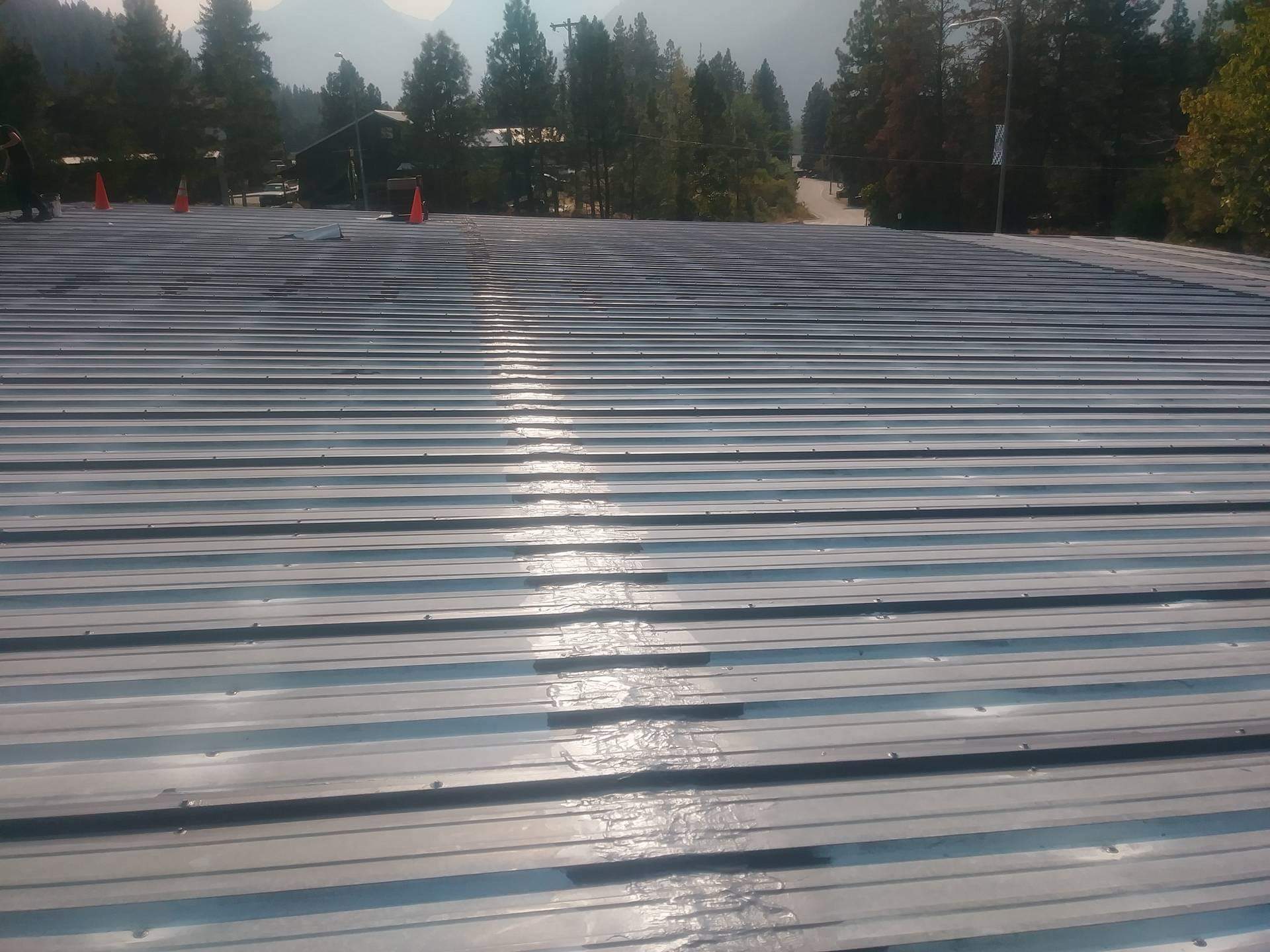 Wide roof coating coverage across a commercial metal roof