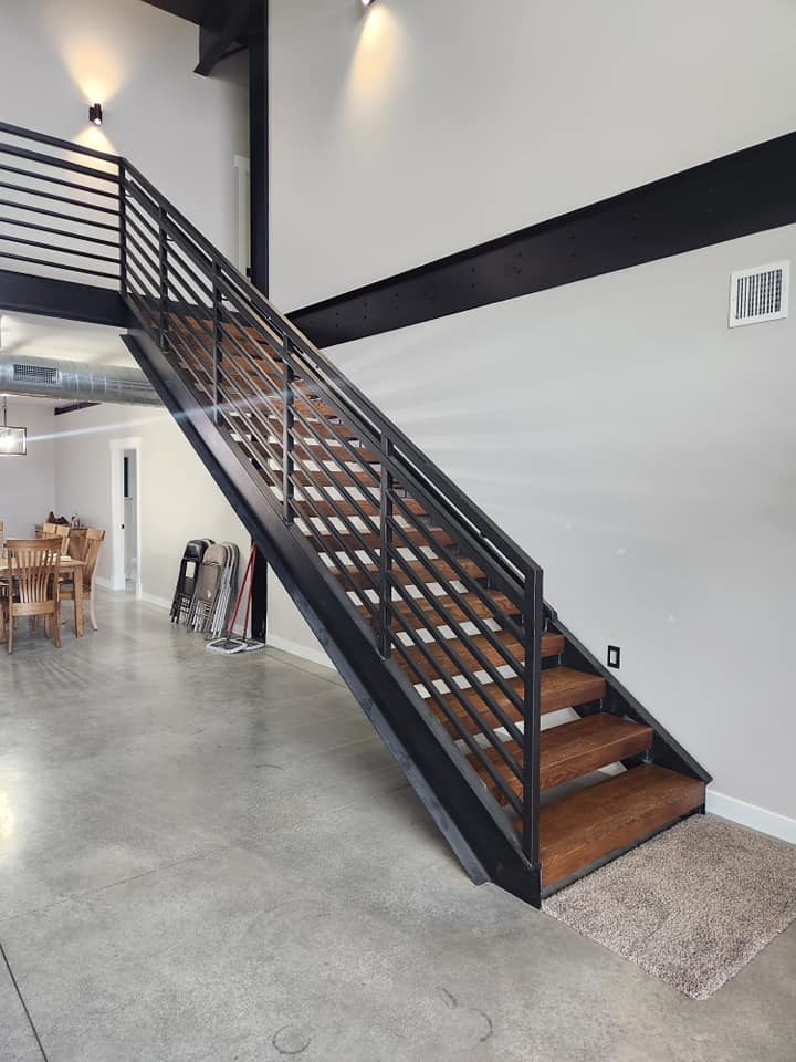 Custom home — custom steel staircase with wood treads leading to loft mezzanine