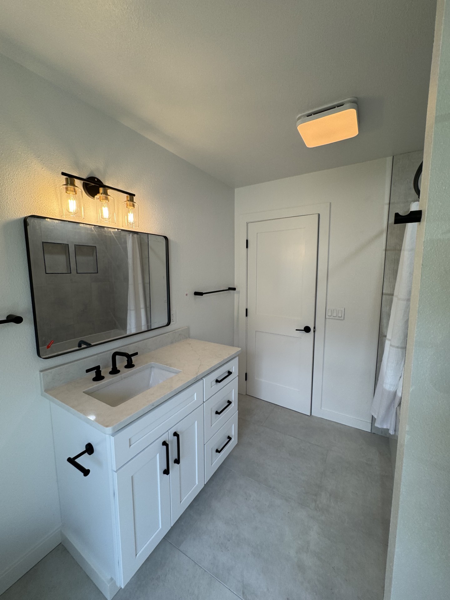 Chelan WA bathroom remodel — vanity view with matte black fixtures and shaker doors